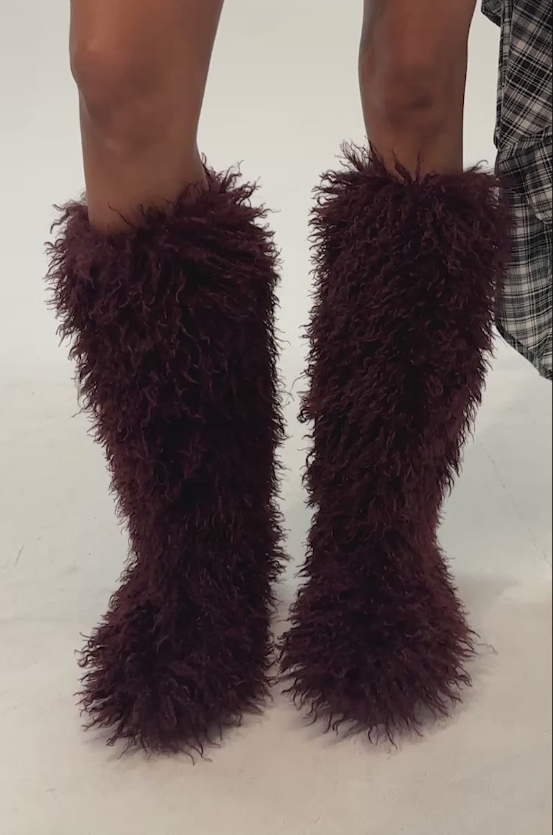 Video of woman modeling the AZALEA WANG DENTON BURGUNDY KNEE HIGH FLAT FUR BOOT—a knee-high, fluffy boot featuring a shaggy faux fur texture in deep burgundy