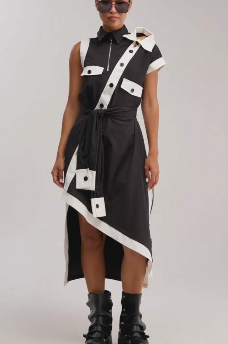 Video of woman modeling the NO FILTER NEEDED BUTTON UP MAXI DRESS and sunglasses standing confidently against a light background, showcasing stylish, fashion-forward workwear.