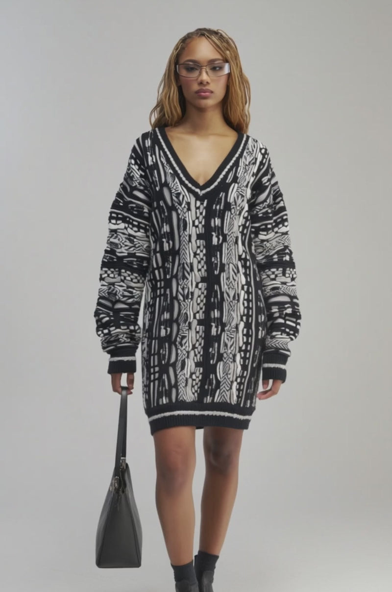 Video of a woman modeling the FEELIN COZY V-NECK SWEATER DRESS IN BLACK AND WHITE.
