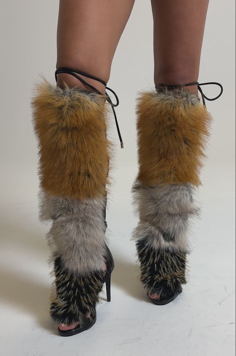 A video of a person wearing black leather shorts and the AZALEA WANG STAMOS BLACK MULTI FUR GLADIATOR STILETTO SANDAL.