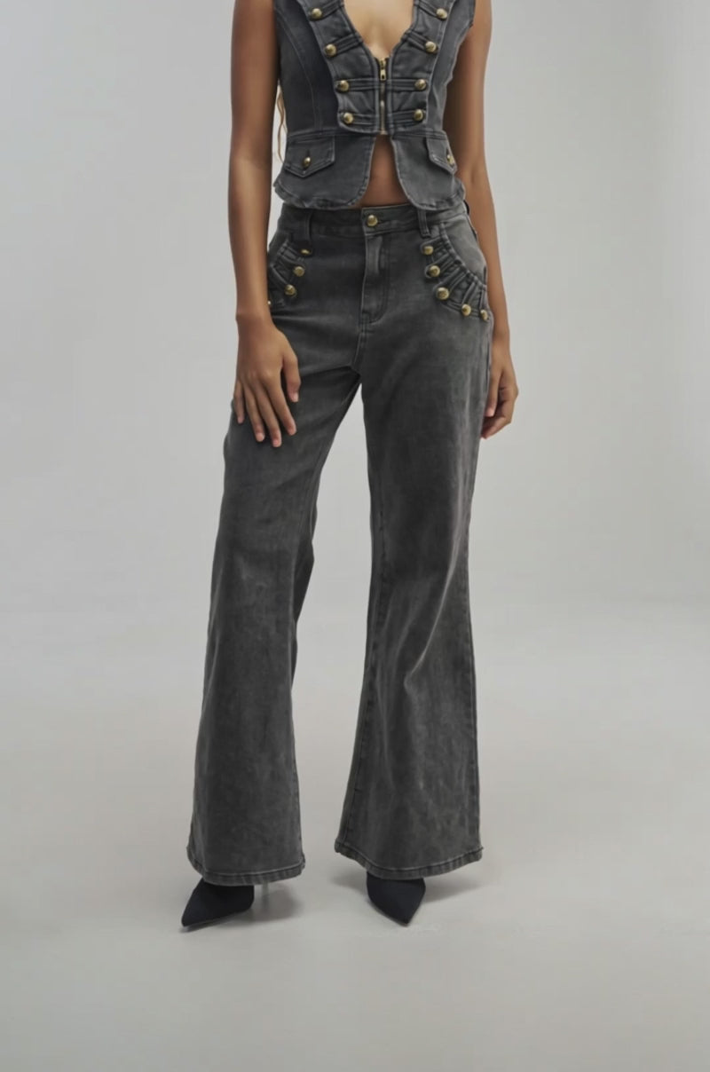 Video of a woman modeling the AHEAD OF THE CURVE MILITARY DENIM PANT—a pair of high-waisted, black washed wide-leg jeans.