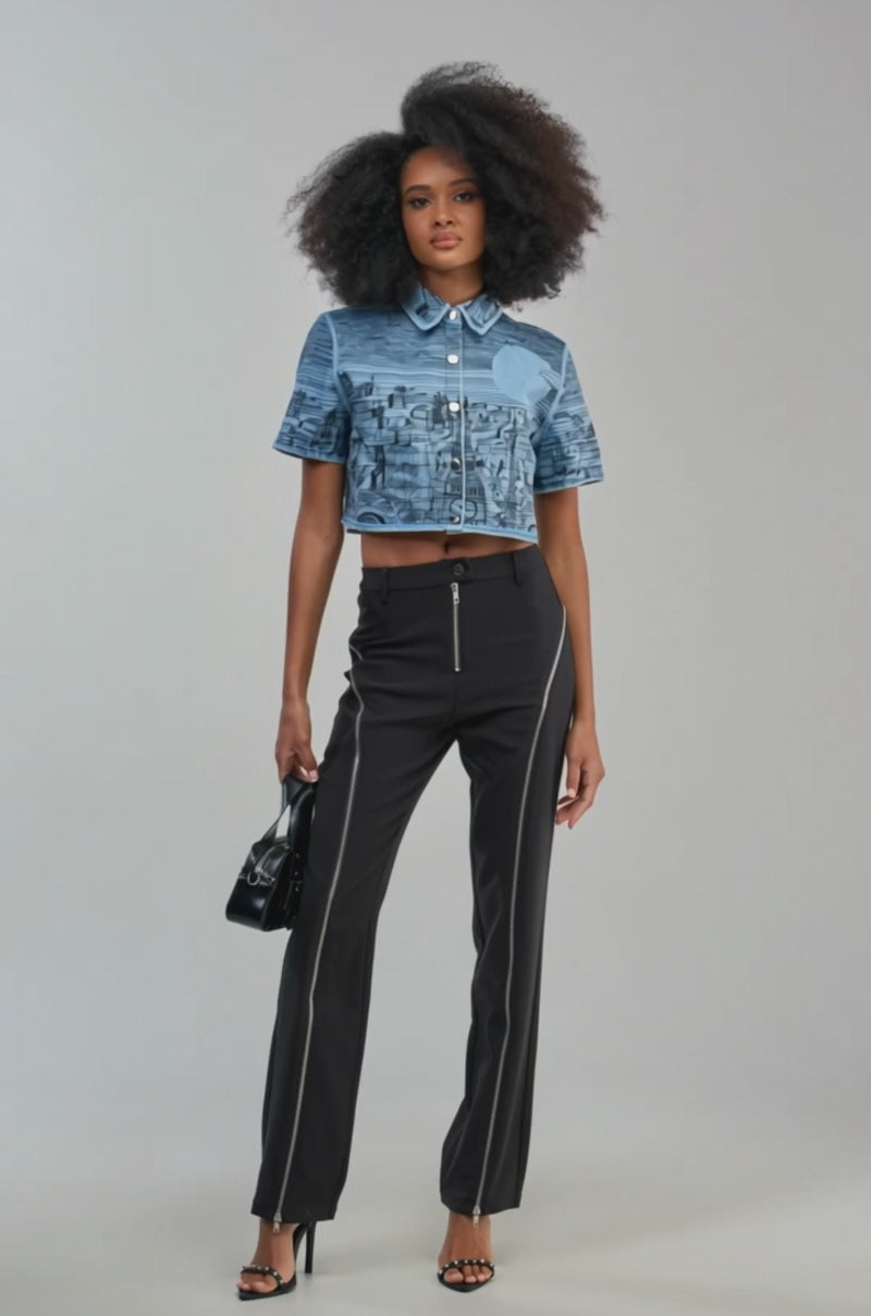 Video of a woman modeling the INK HORIZON EMBROIDERED TOP in light blue denim—a short-sleeve, cropped button-down jacket.