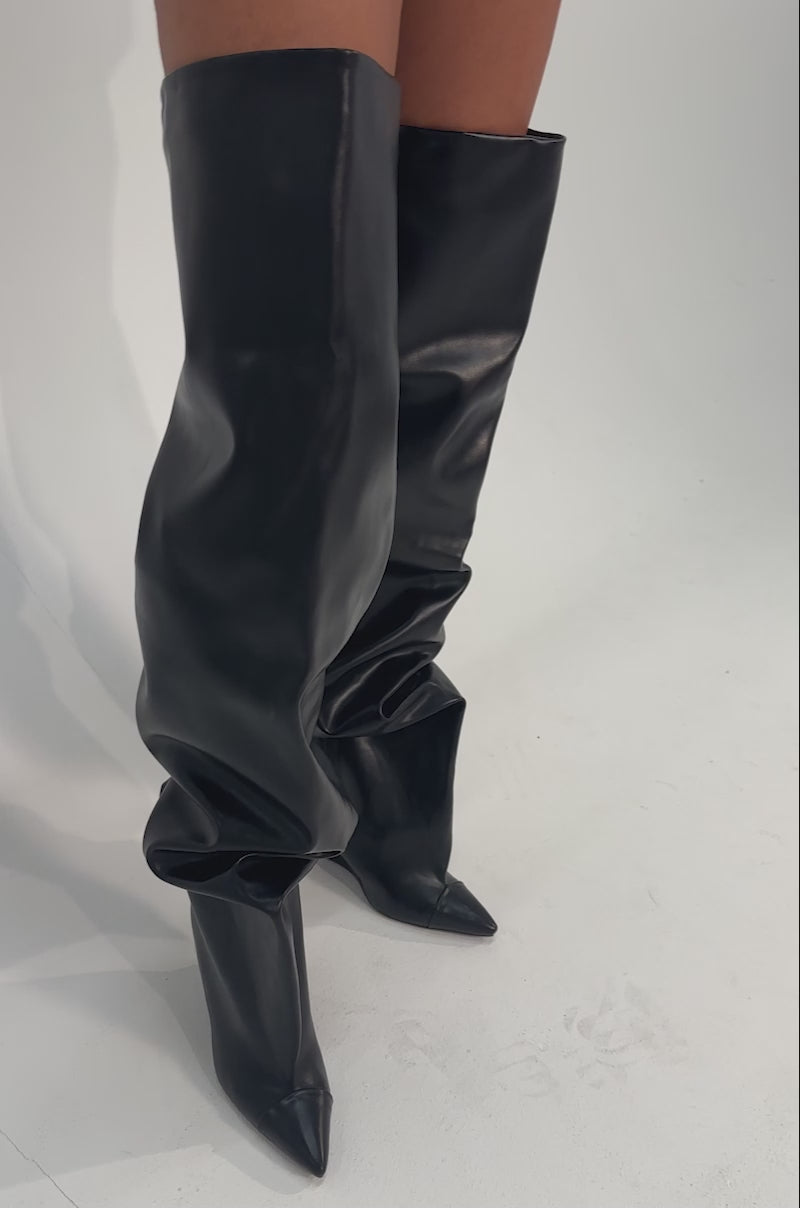 A video of a person wearing the AZALEA WANG GHANA OVER THE KNEE BLACK PU WEDGE BOOT.