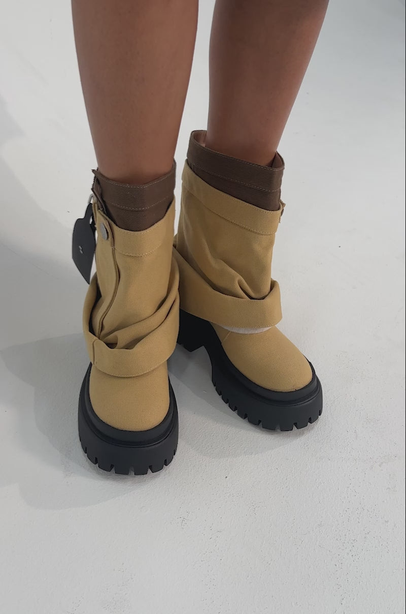 A video of a person wearing the AKIRA GOLD FAE TAN BOOTIE.