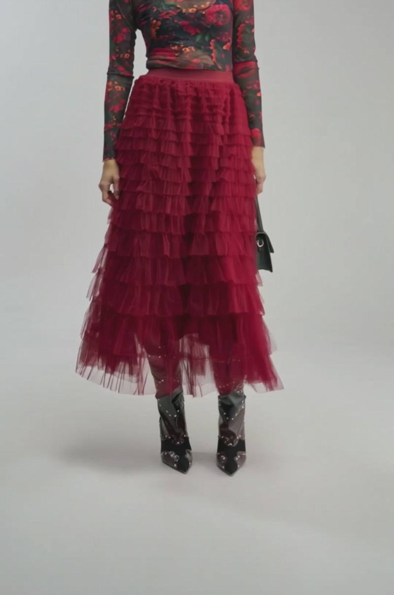 Video of a woman modeling the STARS ALIGNED MESH RUFFLE MAXI SKIRT IN BURGUNDY.