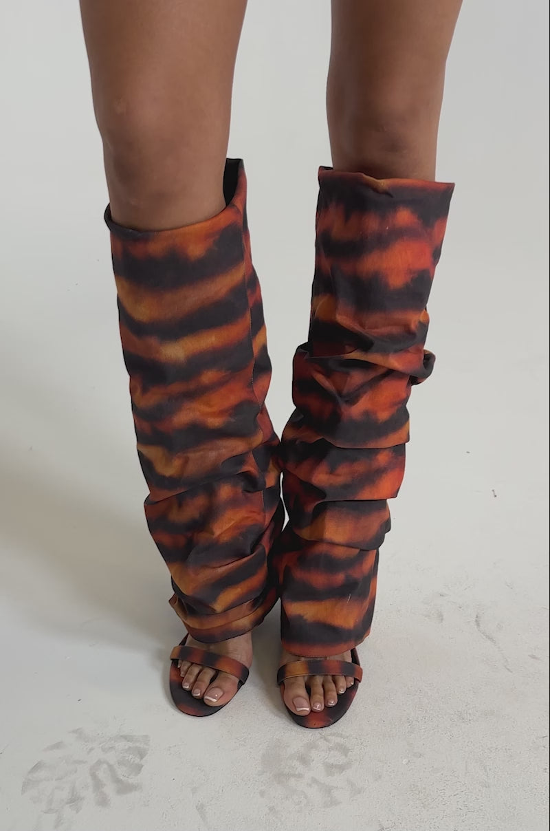 A video of a model wearing the AZALEA WANG RADLEY TIGER PRINT SLOUCHY WEDGE BOOT.