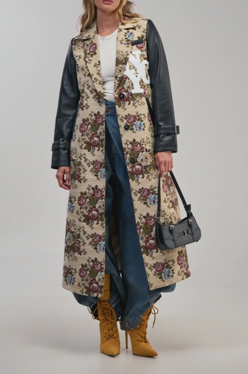 Video of a woman modeling the TAPPED IN VARSITY TRENCH featuring floral tapestry with faux leather sleeve accents.