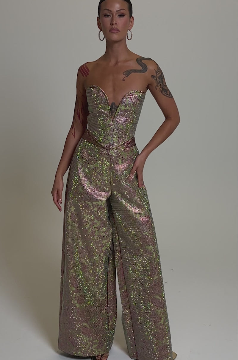 A video of a woman in the TIME AND TIME AGAIN RHINESTONE CORSET, a strapless, shimmery pink and green floral brocade piece with a plunging neckline.