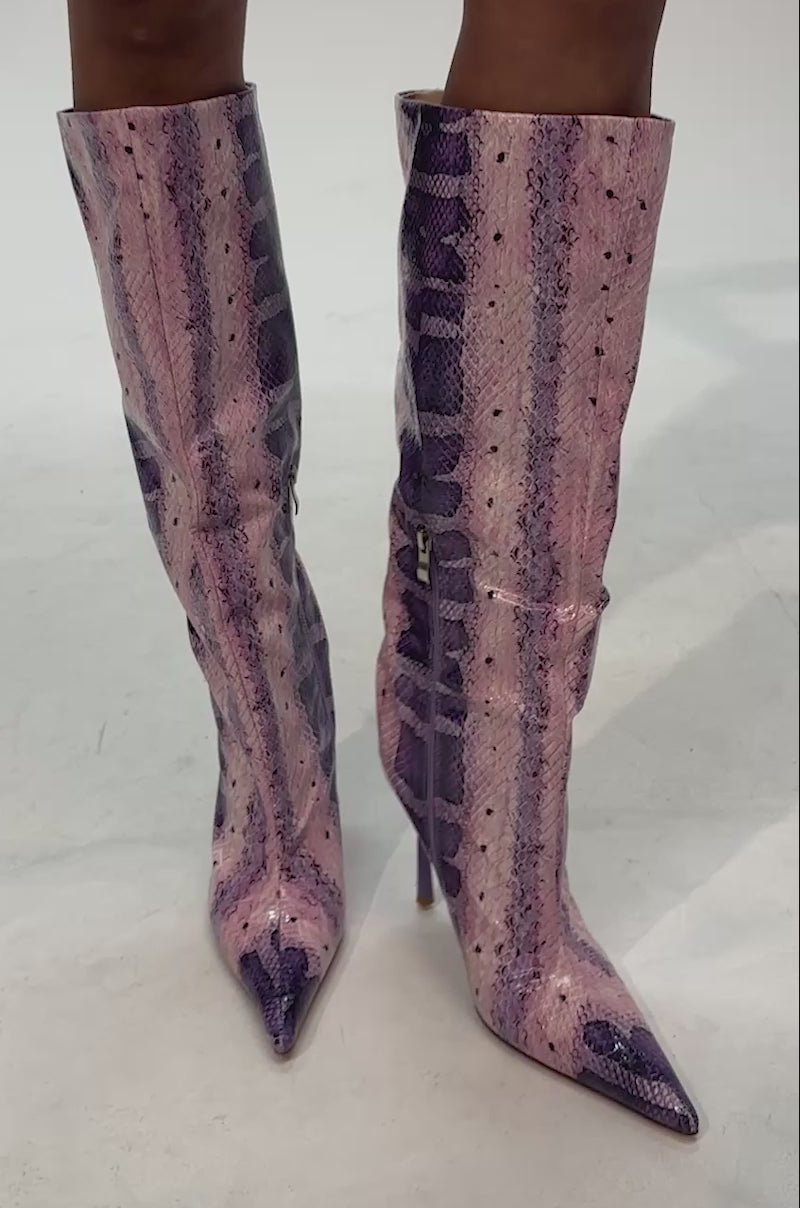 Video of woman modeling the AZALEA WANG MADEYE PURPLE SNAKE KNEE HIGH STILETTO BOOT, featuring an eye-catching purple and pink snakeskin pattern