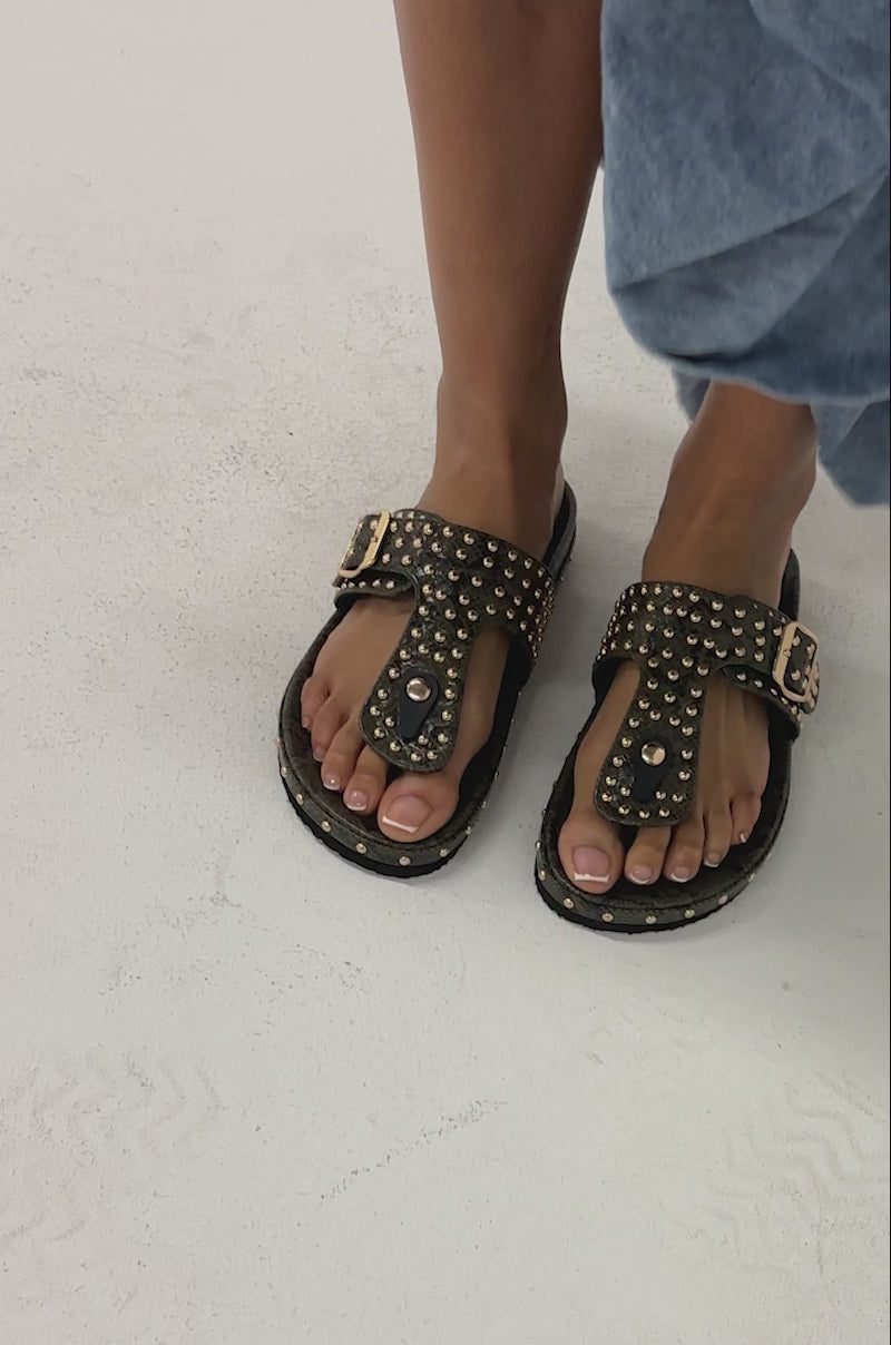 Video of woman modeling the AZALEA WANG DAISY CHAIN GREEN SNAKE STUDDED FLAT SANDALS.