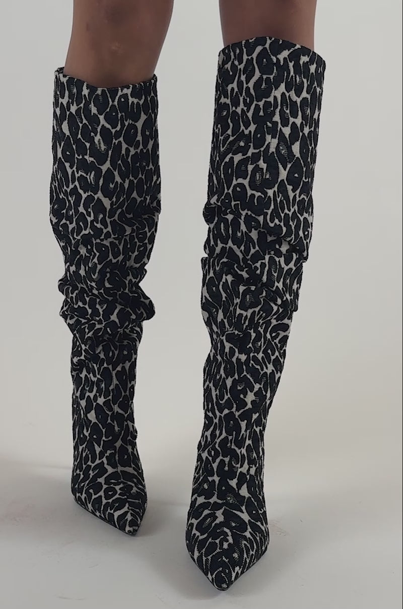 Video of a woman modeling AZALEA WANG STERRE BLACK AND WHITE LEOPARD PRINT STILETTO BOOT. 