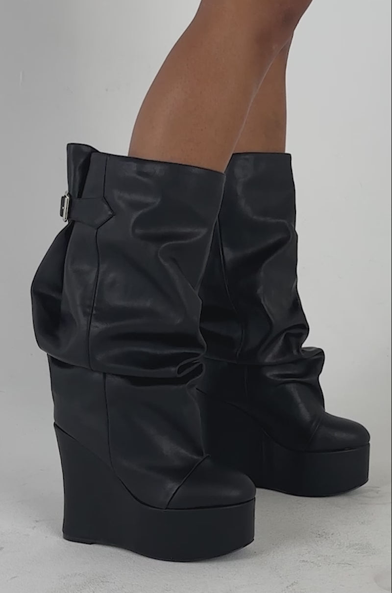 Video of a woman modeling the AZALEA WANG MYTH BLACK WEDGE BOOT.