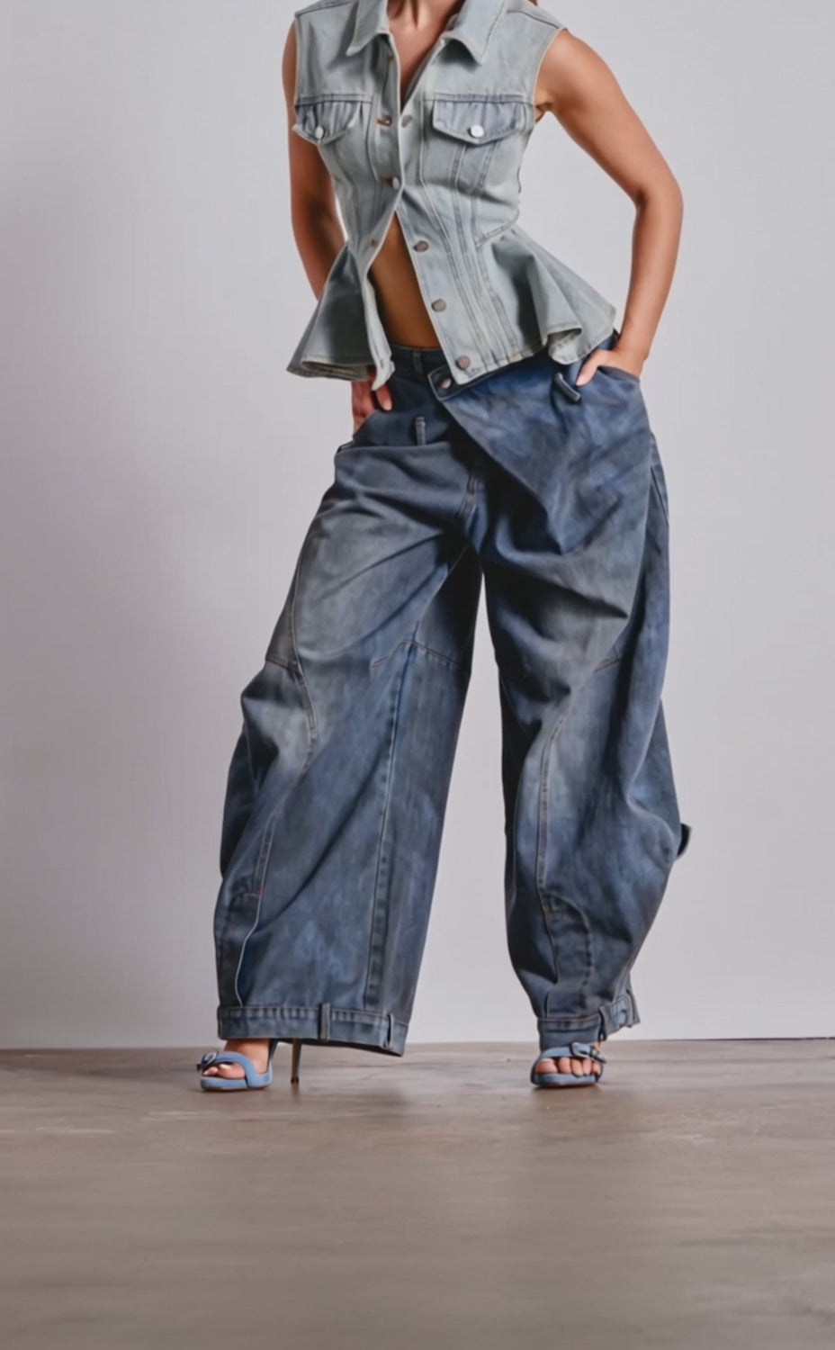 A video of a person wearing IZZY RELAXED DENIM jeans, and a sleeveless denim vest.