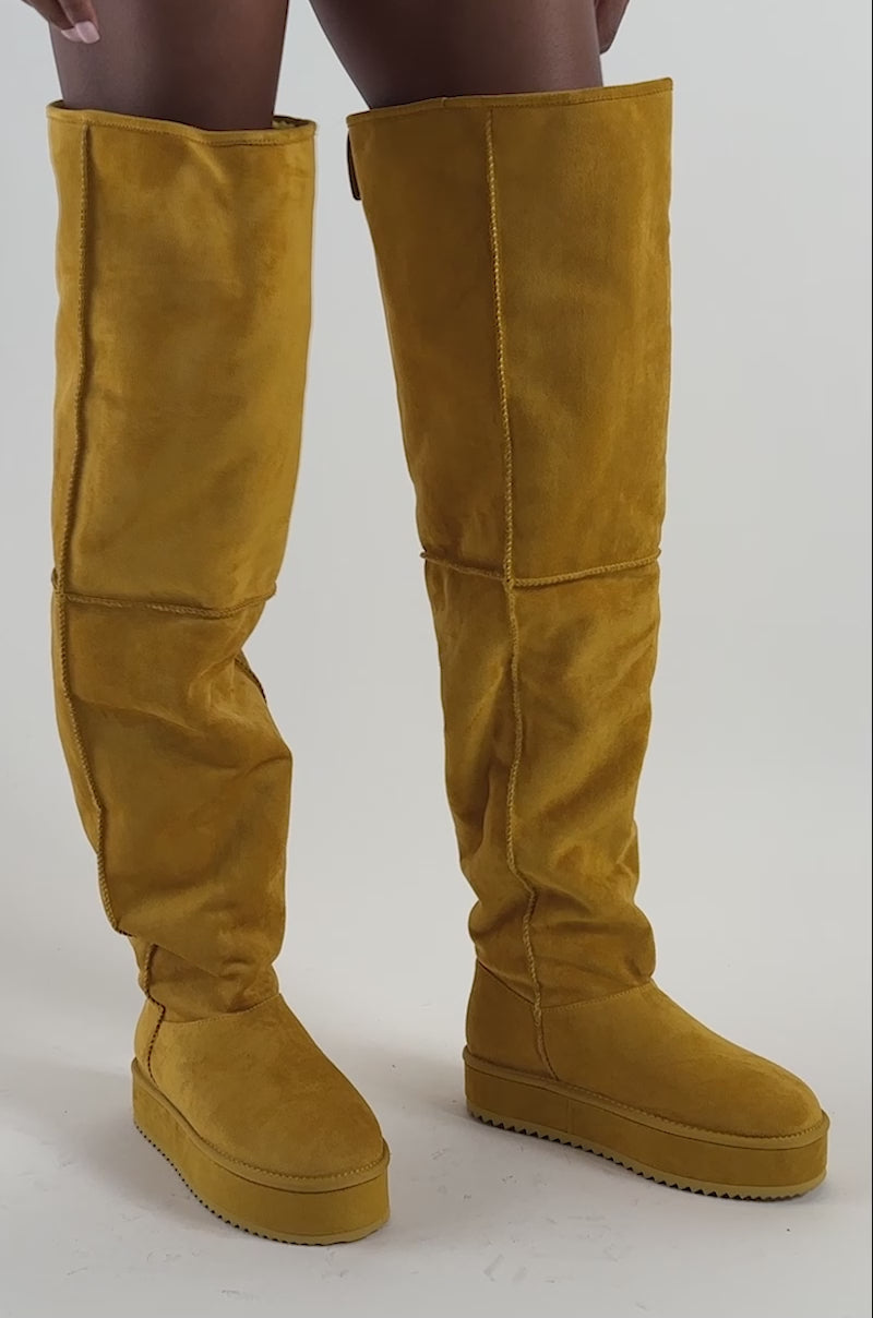 Video of a woman modeling the AZALEA WANG MARLOW MUSTARD SUEDE SHERPA FLATFORM BOOT.