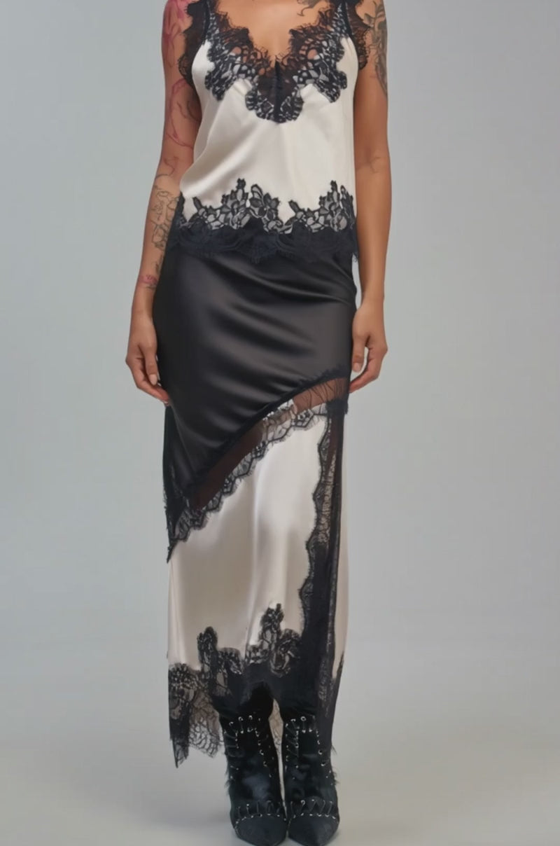 Video of a woman modeling the SHINE BRIGHT SATIN BLOUSE in cream and black lace.