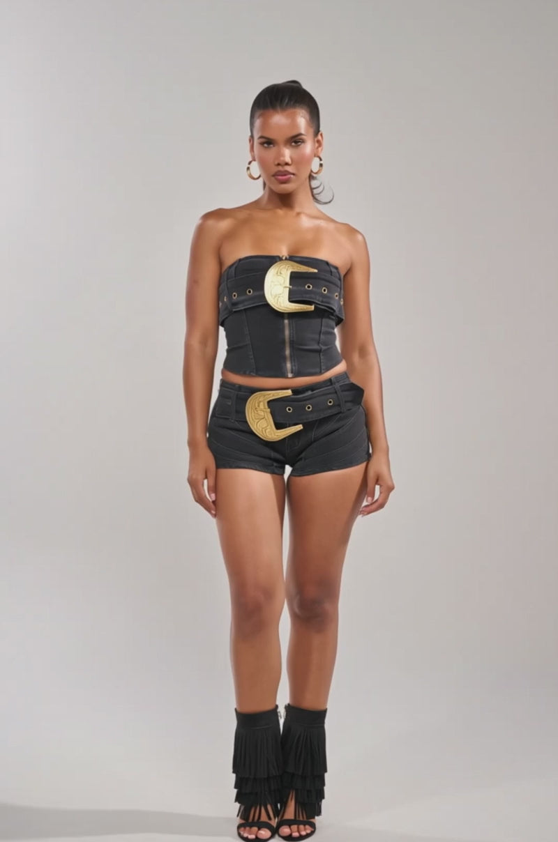 Video of woman modeling the BUCKIN DENIM TUBE TOP, a western-inspired black denim corset adorned with large, ornate gold belt buckles.