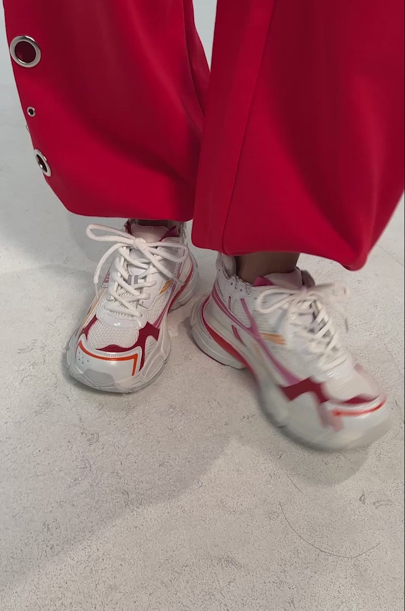 Video of woman modeling the AKIRA GOLD MELAE WHITE AND PINK SNEAKER.