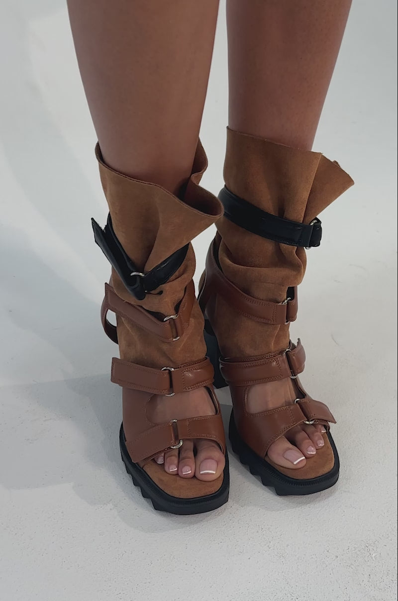 A video of a person wearing the AZALEA WANG THIERRY TAN FAUX SUEDE OPEN TOE CHUNKY BOOTIE.
