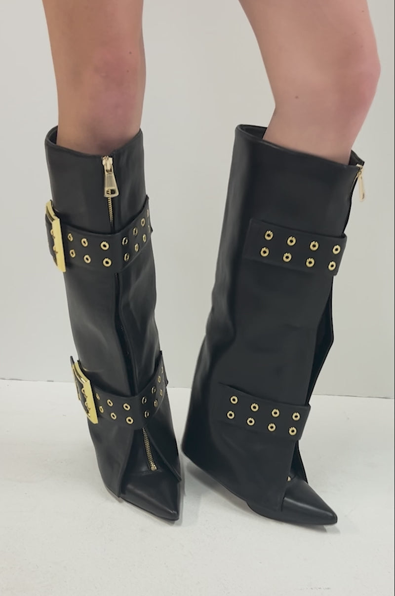 Video of person standing against a plain white background, wearing the AZALEA WANG ROOVER Black Hardware Embellished Stiletto Boots.