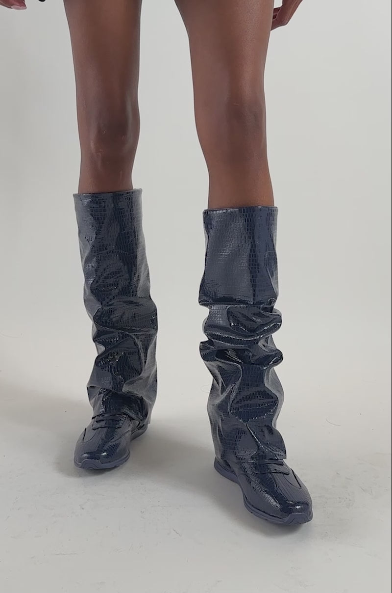 Video of a woman modeling the AZALEA WANG STRIDE NAVY CROC SNEAKER BOOTS.