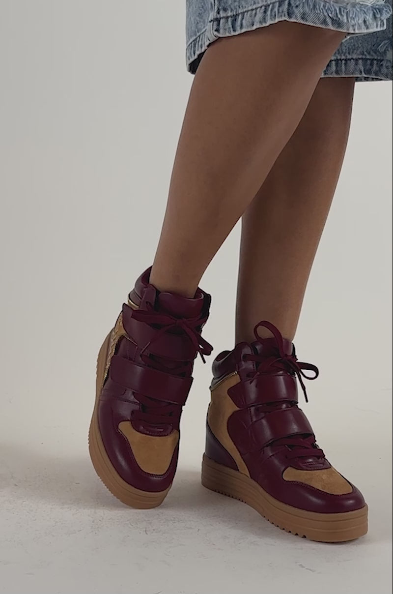 Video of a woman modeling the AZALEA WANG LUMUS Burgundy Wedge Sneaker with shiny detail.