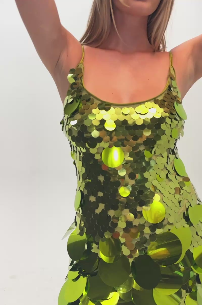 Video of a woman modeling the BOLD AND BRIGHT SEQUIN MINI DRESS IN GREEN, featuring eye-catching large green sequins.