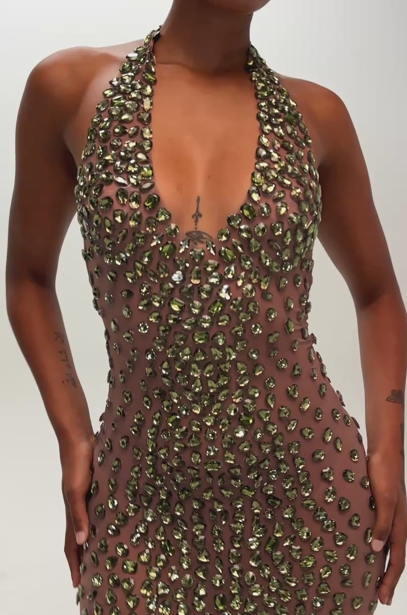 Video of a woman modeling the IN THE DETAILS GEM MESH MINI DRESS, a sleeveless, form-fitting design adorned with emerald rhinestones.