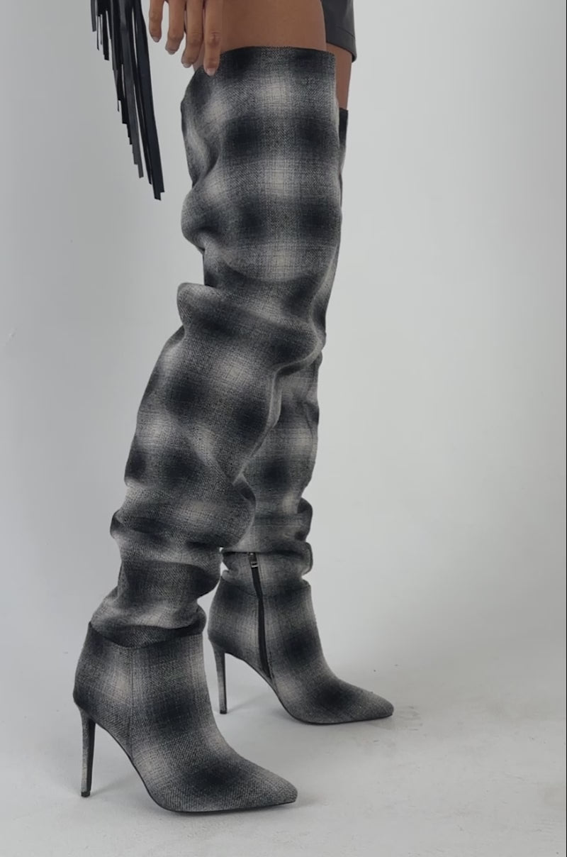 Video of a woman modeling the AZALEA WANG BOMBSHELL PLAID THIGH HIGH BOOT—a ruched, black-and-white plaid stiletto statement boot.