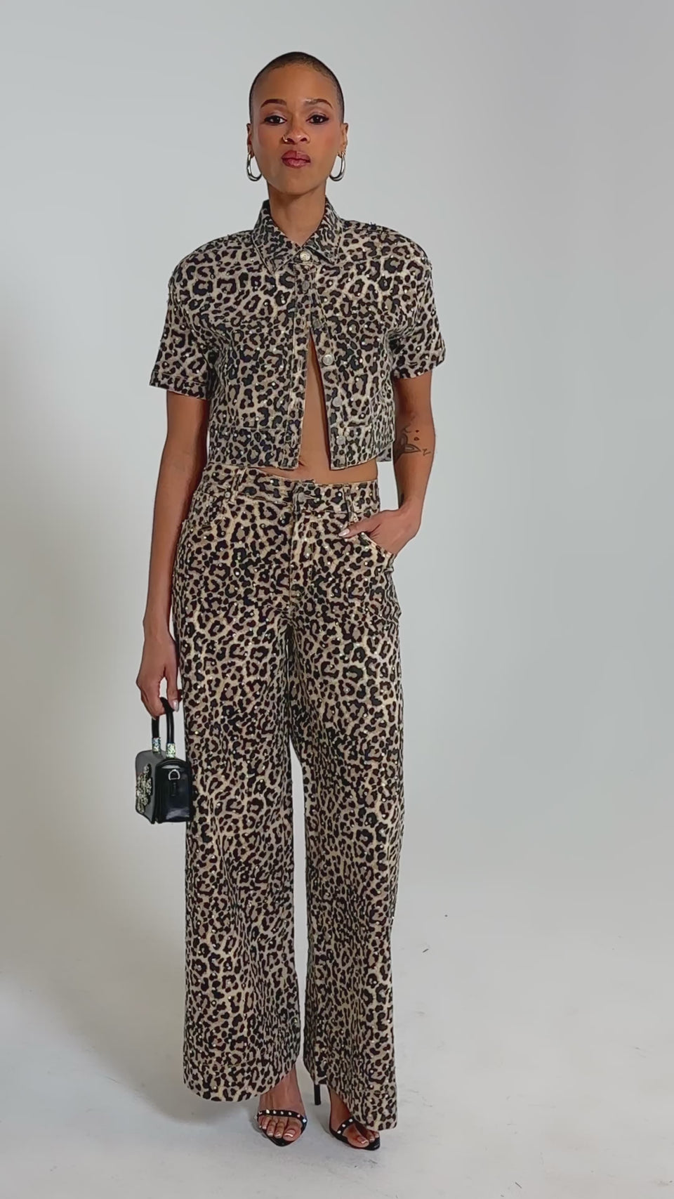 Video of woman modeling the LEOPARD SISTA BUTTON DOWN with matching high-waisted leopard print pants, standing confidently against a plain background.