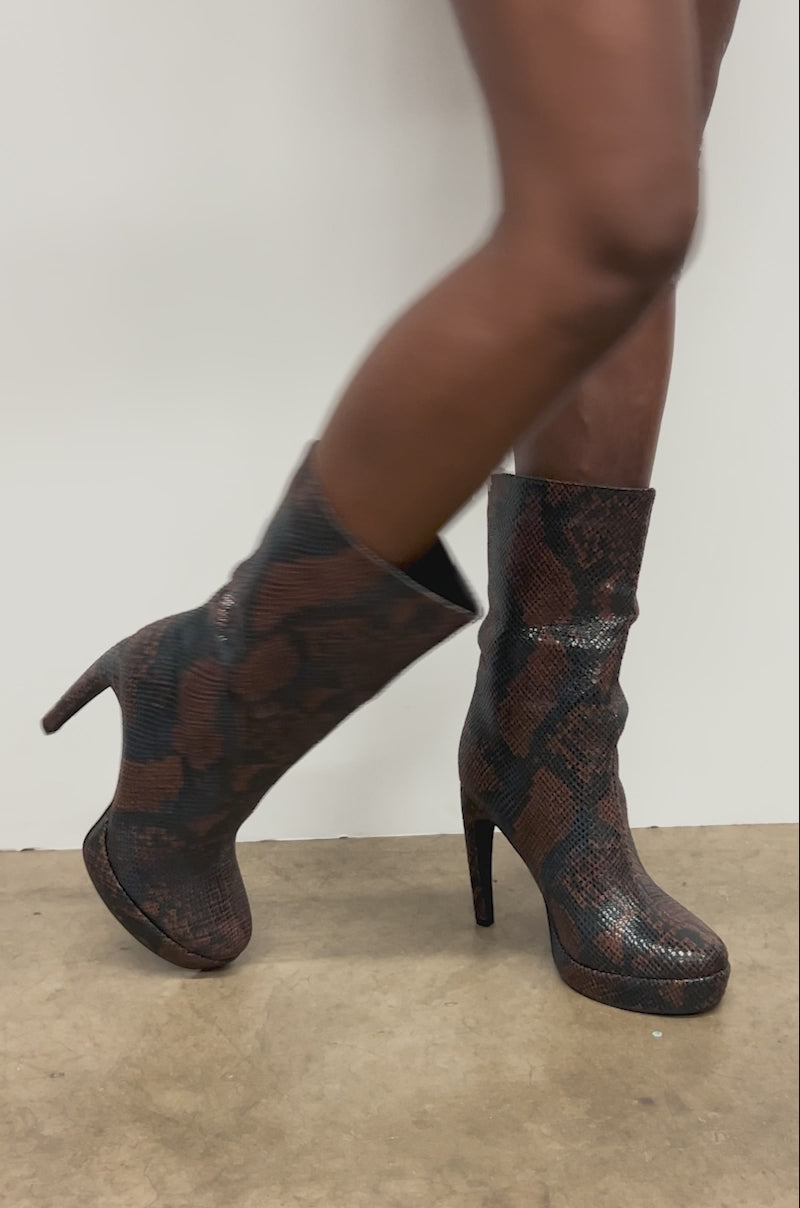 Video of woman modeling the AZALEA WANG WENONA BROWN MULTI SNAKE BOOTIE with a bold snakeskin pattern.