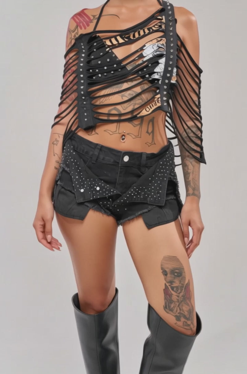 Video of woman modeling the CHELLA DISTRESSED TOP adorned with studs.