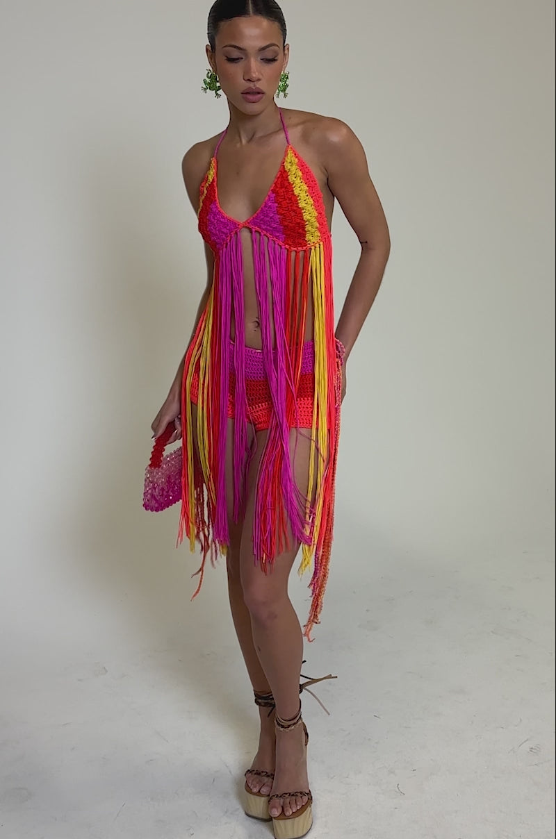 Video of woman modeling the BEACHIN CROCHET BRALETTE with pink, orange, and yellow tassels, paired with matching pink crochet shorts 