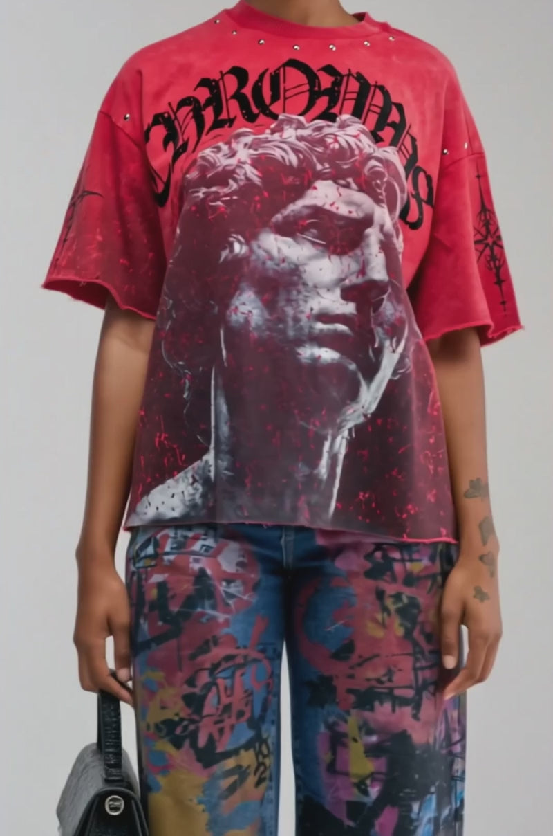 Video of a woman modeling the FIRST ROW ONLY HUMAN GRAPHIC TEE—an oversized, relaxed fit shirt with a bold graphic and statement text.