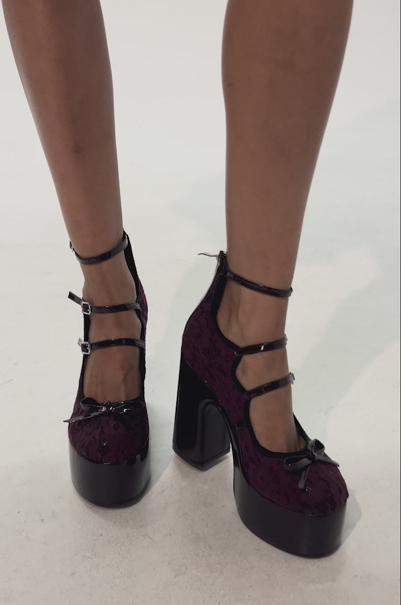 Video of woman modeling the AZALEA WANG SPROUT Burgundy Mary Jane Platform Pumps with bow detail, featuring high heels and posed against a light background.