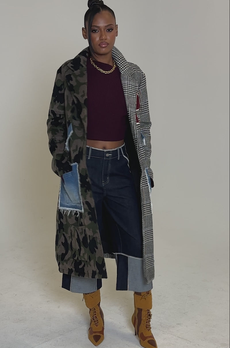 Video of woman modeling the MADDIX HALF HALF TRENCH with plaid details and denim patch pockets, paired with wide-leg cropped jeans, brown boots, a burgundy top, and a bold red "P" patch.