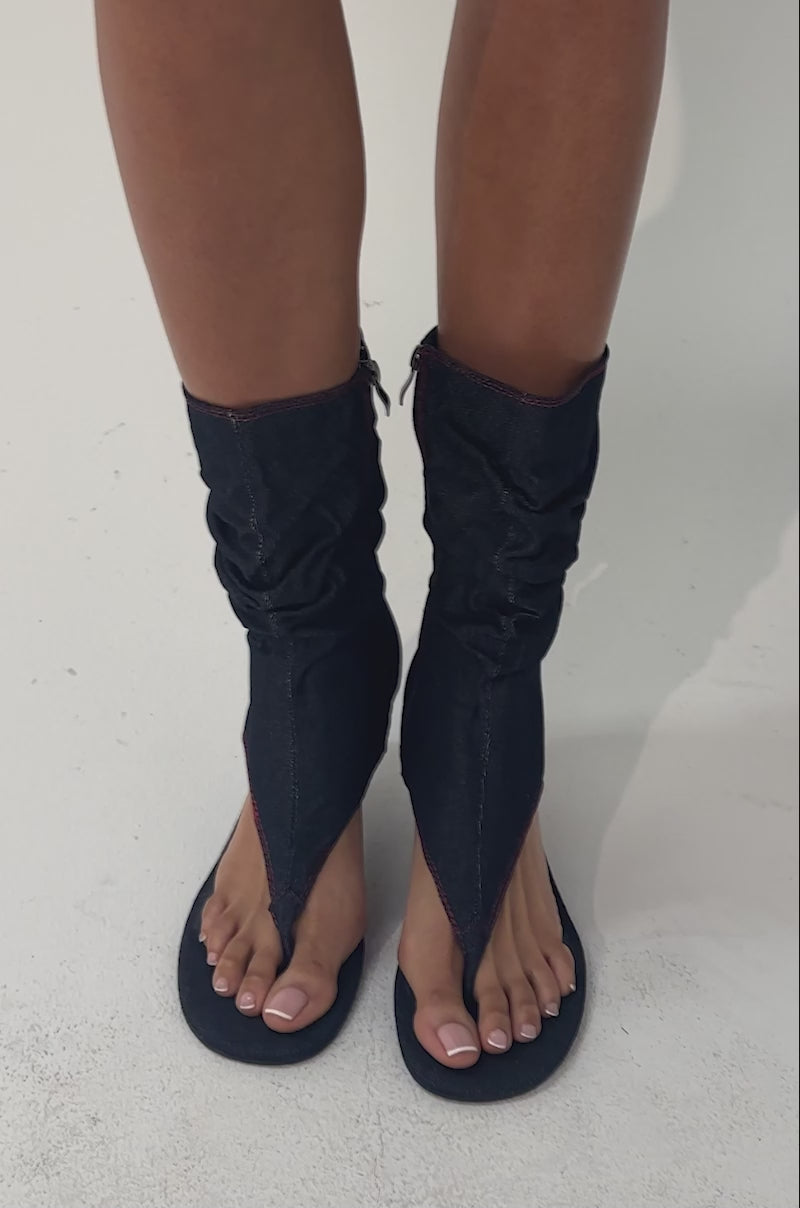 A video of a person wearing the AZALEA WANG NIAMH DENIM GLADIATOR KITTEN HEEL SANDALS.