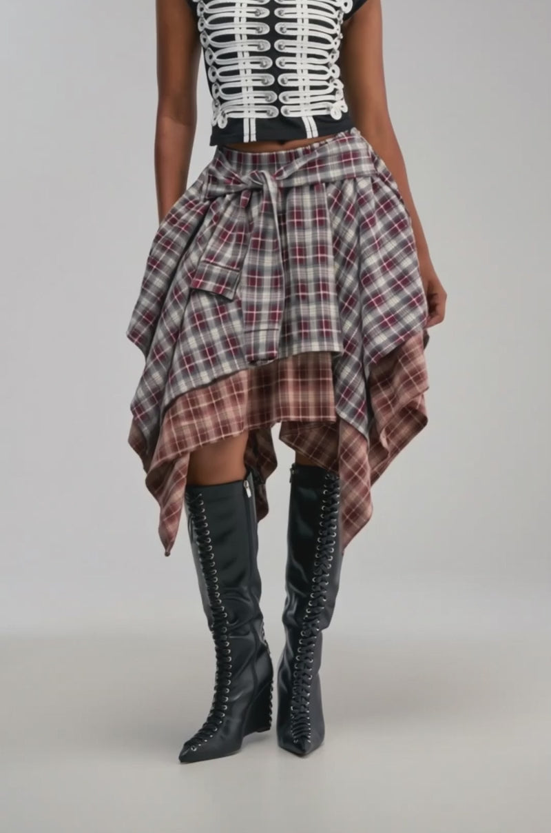 Video of a woman modeling the FEELING ALL OVER THE PLACE PLAID MIDI SKIRT—a layered, handkerchief hem piece in striking red and gray plaid.