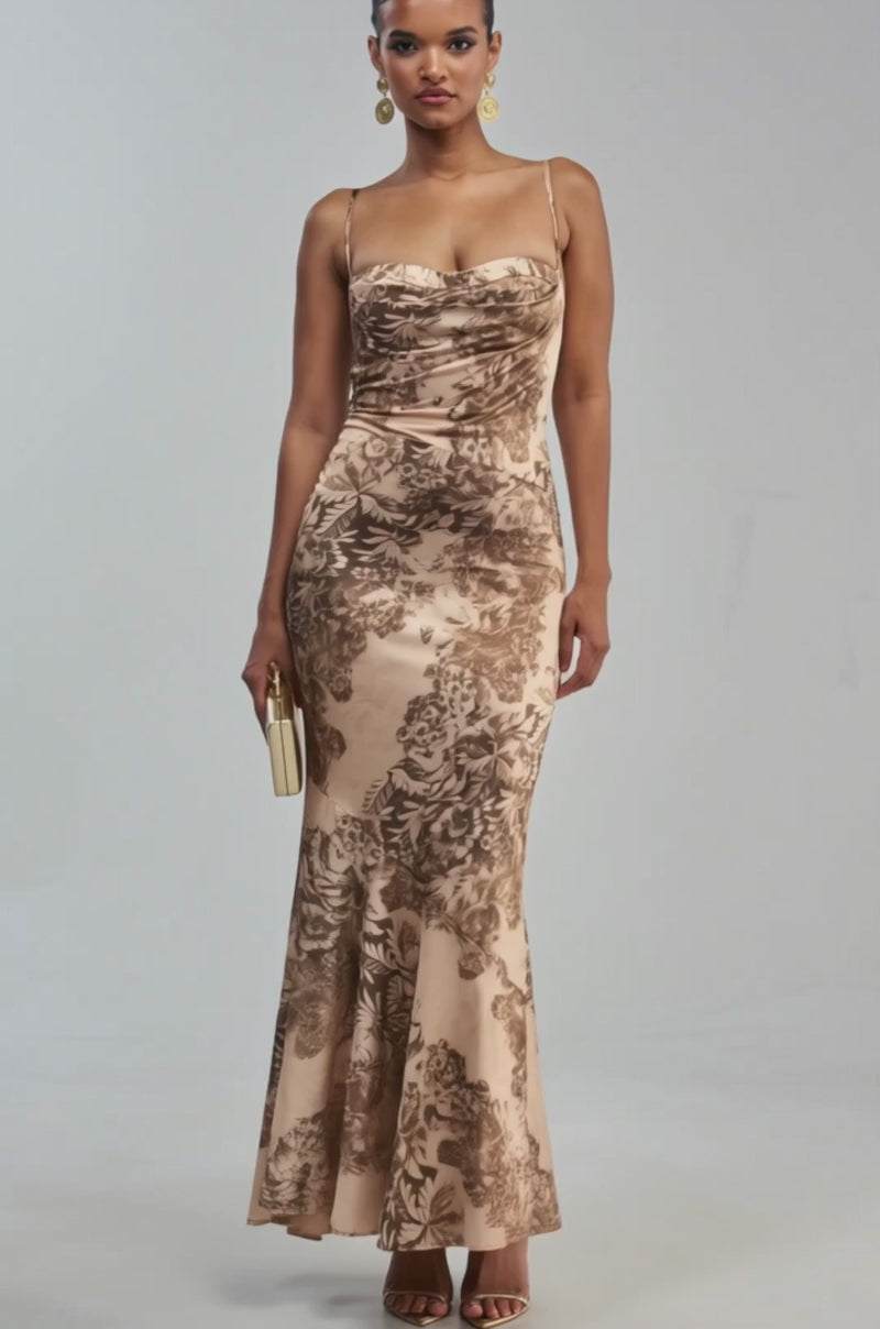 Video of a woman modeling the SATIN SHOWSTOPPER PRINTED MAXI DRESS—a sleeveless, form-fitting beige floral satin maxi.