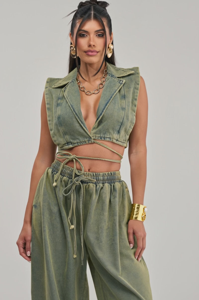 Video of a woman modeling the GUESS WHO V-NECK COLLARED BLOUSE IN DENIM, styled sleeveless as a crop top.