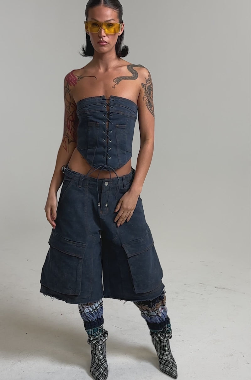A video of a woman in the BOLD BERMUDA SHORT dark-wash cargo shorts.