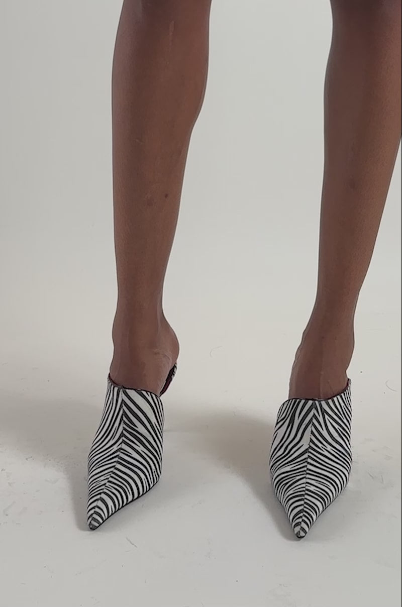Video of a woman modeling the AZALEA WANG ANNIKA ZEBRA PRINTED MULE STILETTO PUMPS.