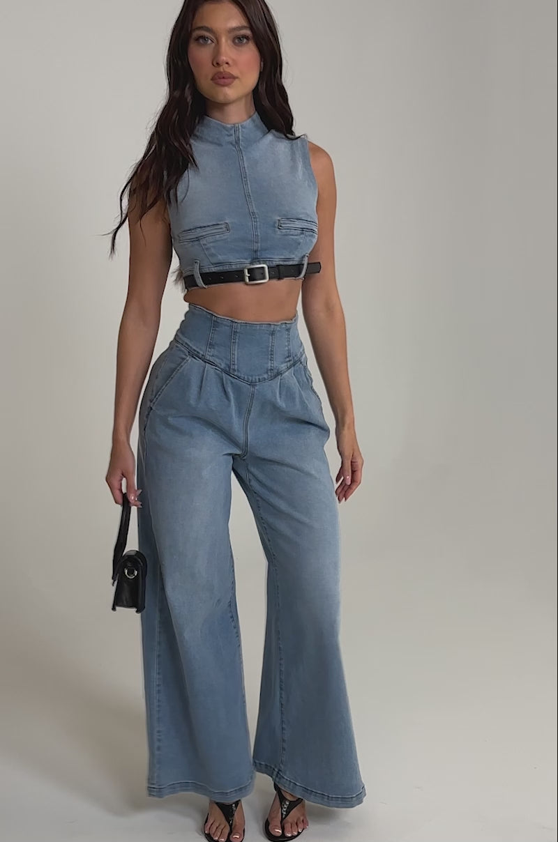 A video of a woman in the JENNY DENIM BLOUSE, paired with high-waisted wide-leg jeans. 
