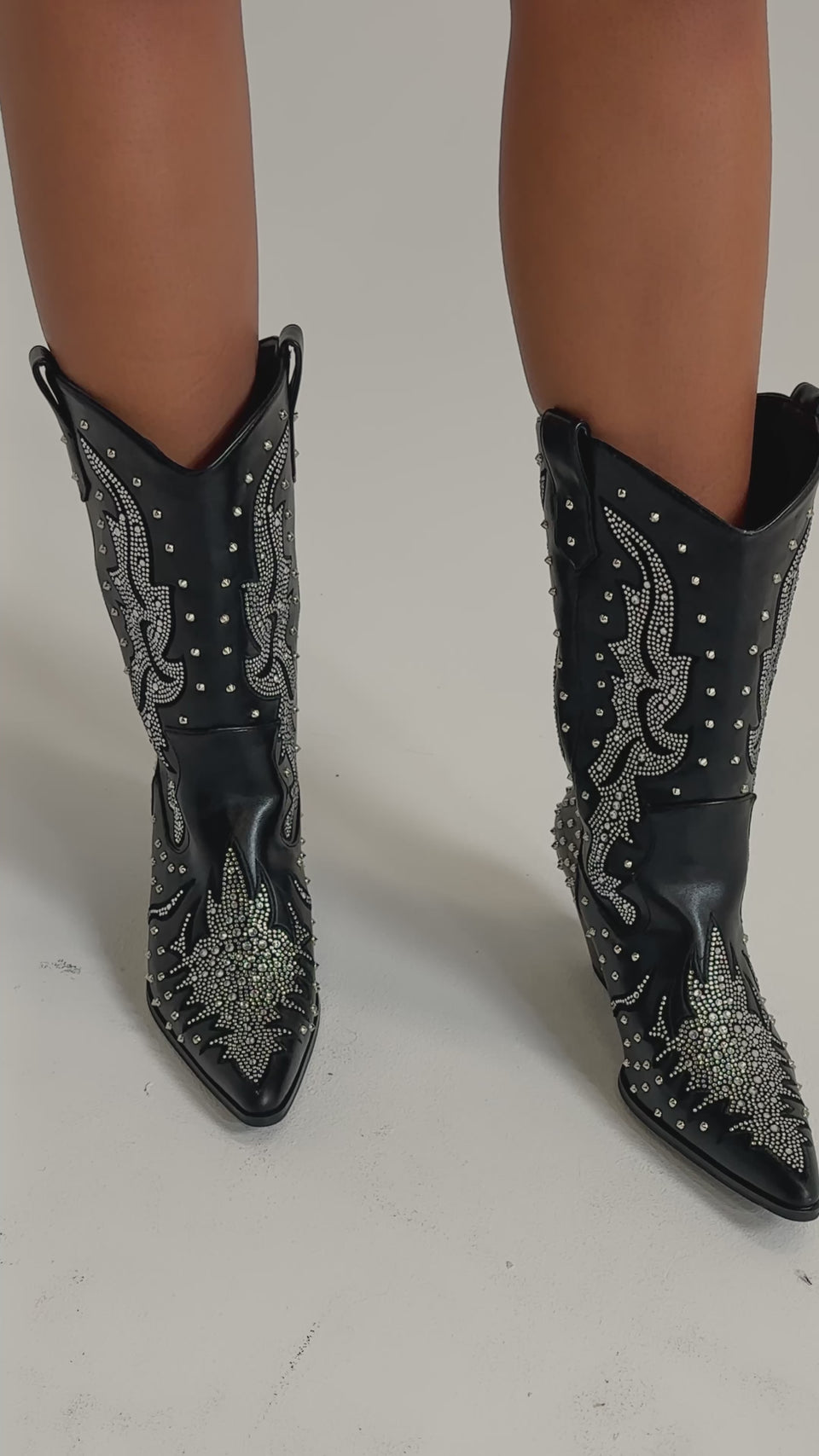 A video of a person wearing black leather shorts and the AZALEA WANG ANKUS BLACK WESTERN RHINESTONE BOOT.