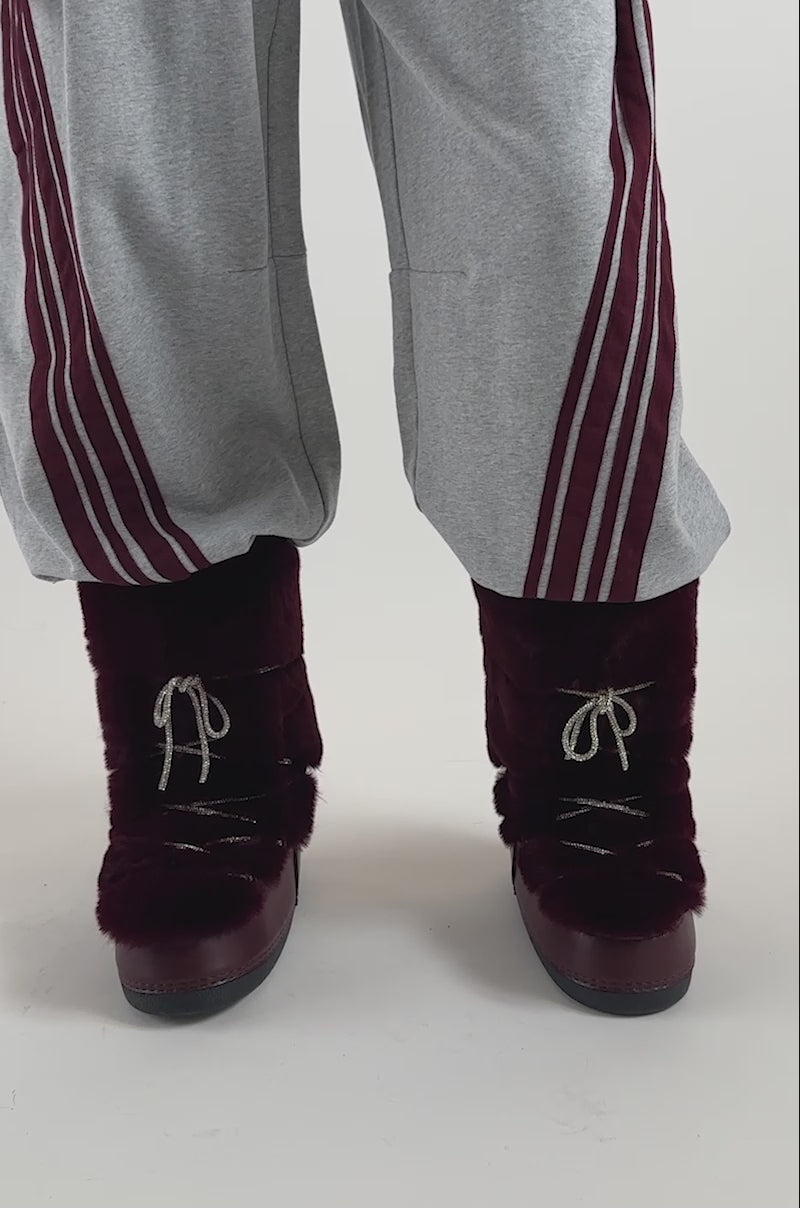 Video of a woman modeling the AZALEA WANG KARMELA BURGUNDY FUR MOON BOOT.