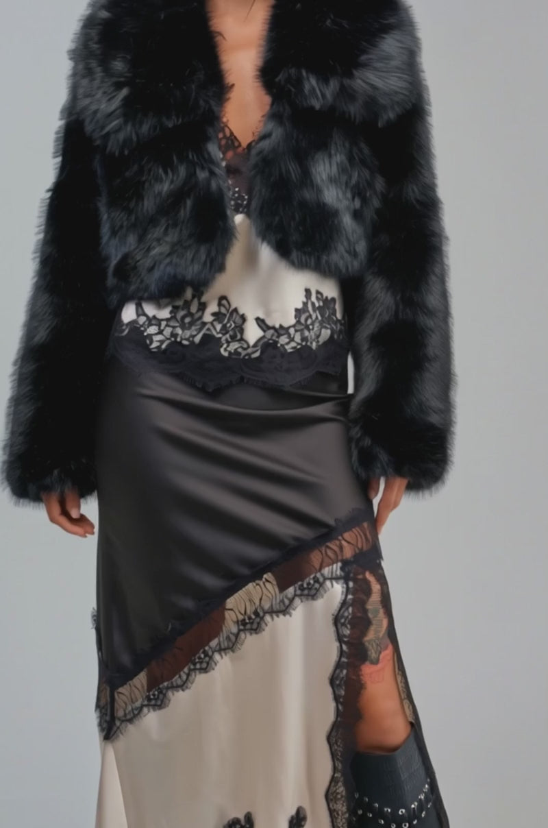 Video of a woman modeling the CADENCE CROPPED FAUX FUR IN BLACK.