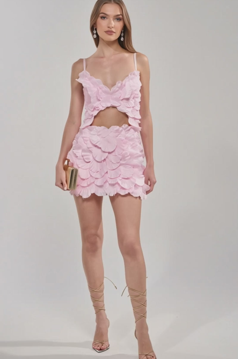 Video of woman modeling the CAUGHT YOUR ATTENTION FLORAL APPLIQUE MINI DRESS with thin straps 