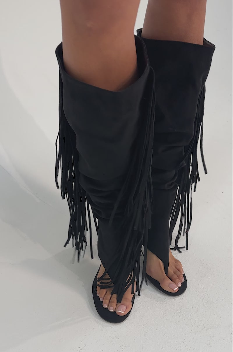 A video of a person wearing the AZALEA WANG JOHANNA BLACK FRINGE GLADIATOR SANDALS. 