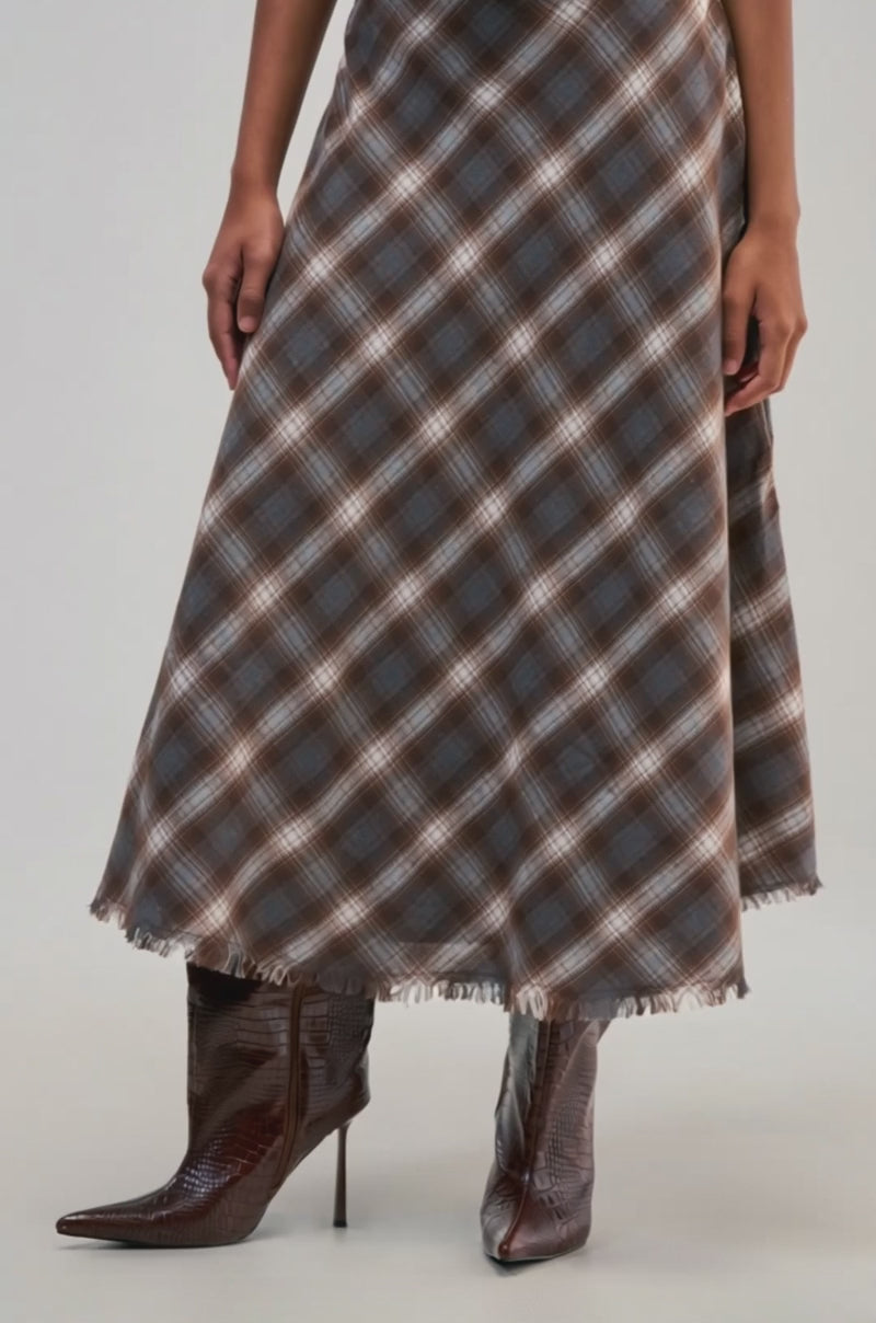 Video of a woman modeling the DRIFT AWAY PLAID MIDI SKIRT with a frayed hem.