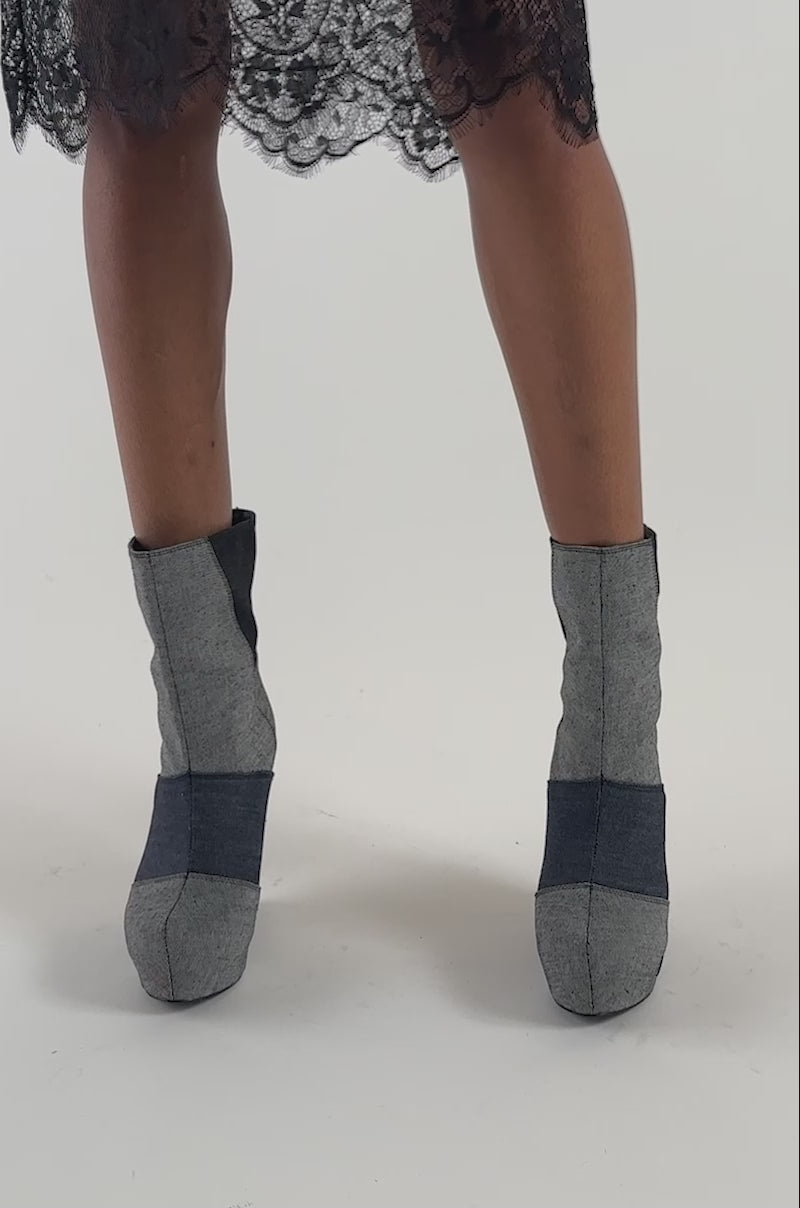 Video of a woman modeling the AKIRA GOLD HELISENT DENIM PATCHWORK WEDGE BOOTIE.