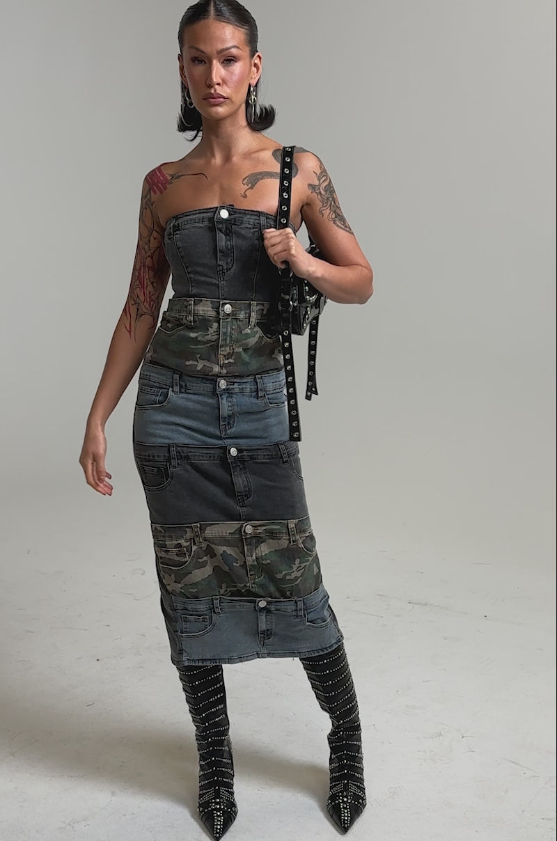 A video of a model wearing the PATCHWORK PARADOX DENIM MAXI DRESS with camo panels.